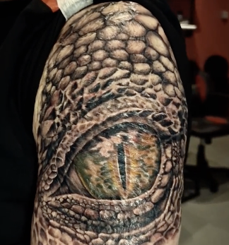 dragon eye tattoo on bicep